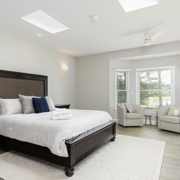A king-size bed in the primary suite at The Nest at Swan Point airbnb vacation rental in Colonial Beach, Virginia.