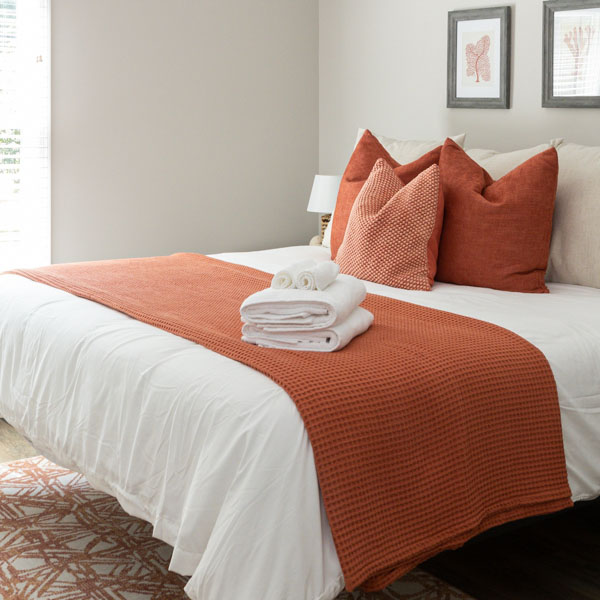 A king-size bed in the Coral Room at The Nest at Swan Point airbnb vacation rental in Colonial Beach, Virginia.