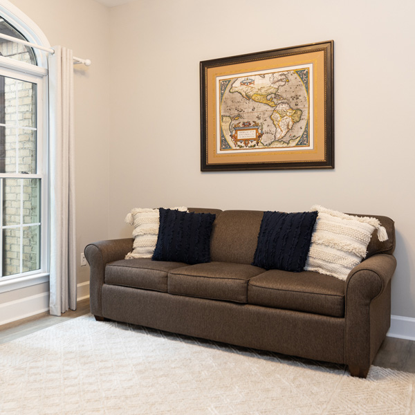 An office space with a sofa that converts to a queen-size bed at The Nest at Swan Point airbnb vacation rental in Colonial Beach, Virginia.